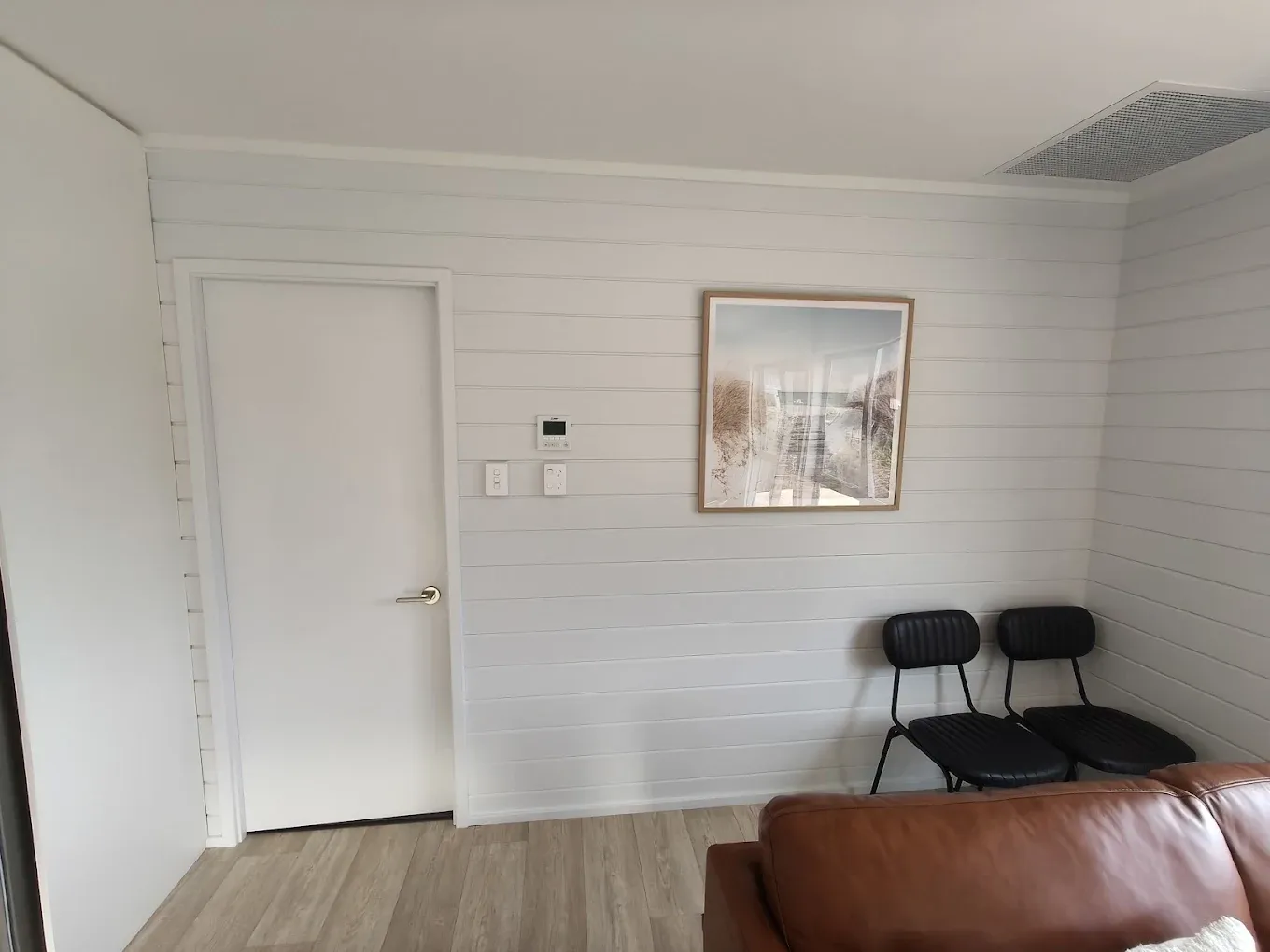 Lounge with framed art and white painted walls